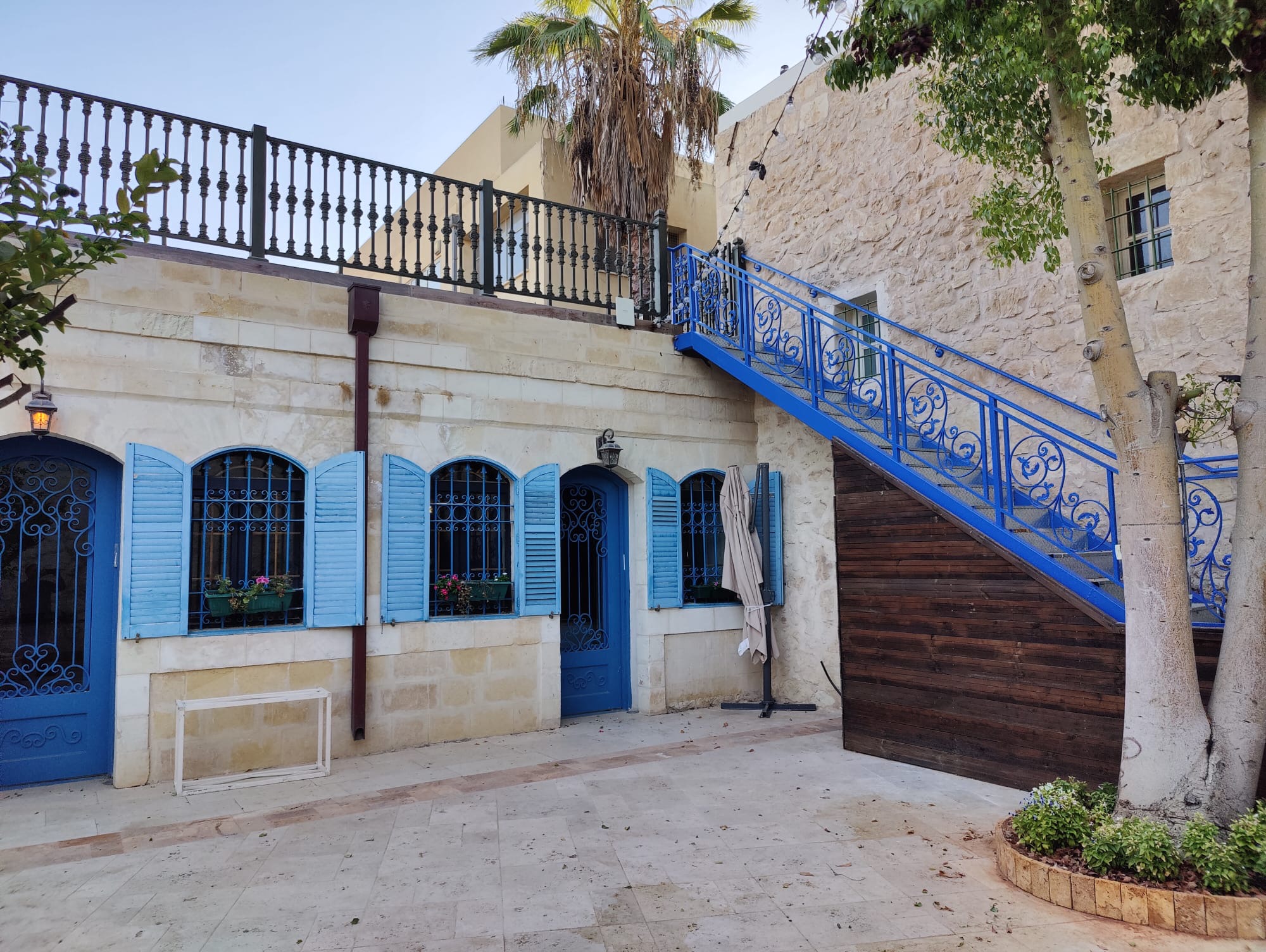 Historic stone facade with Mediterranean blue shutters